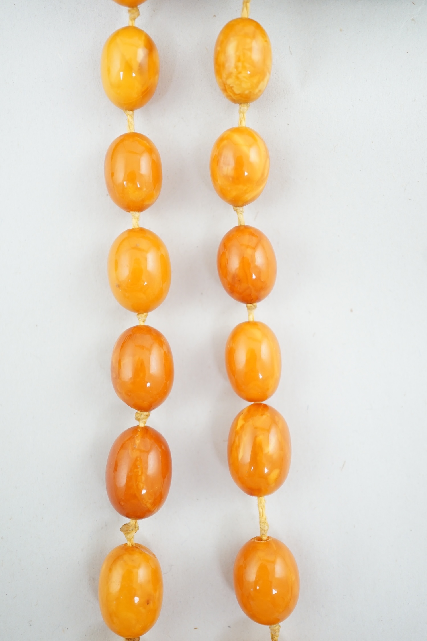 A single strand graduated oval amber bead necklace